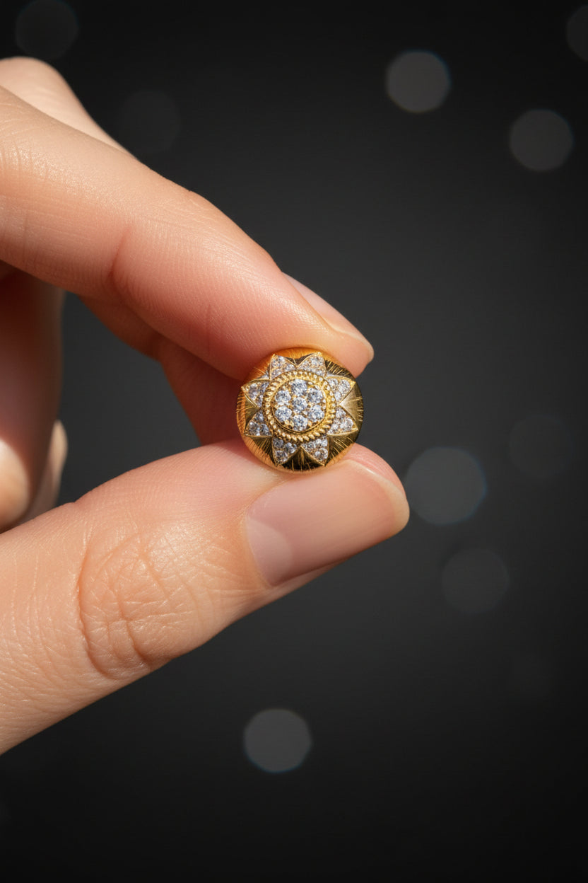 Gold and diamond ring held in a hand with grass in the background - Ali & Eve Jewels