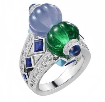 Ring with blue and green gemstones on a white background