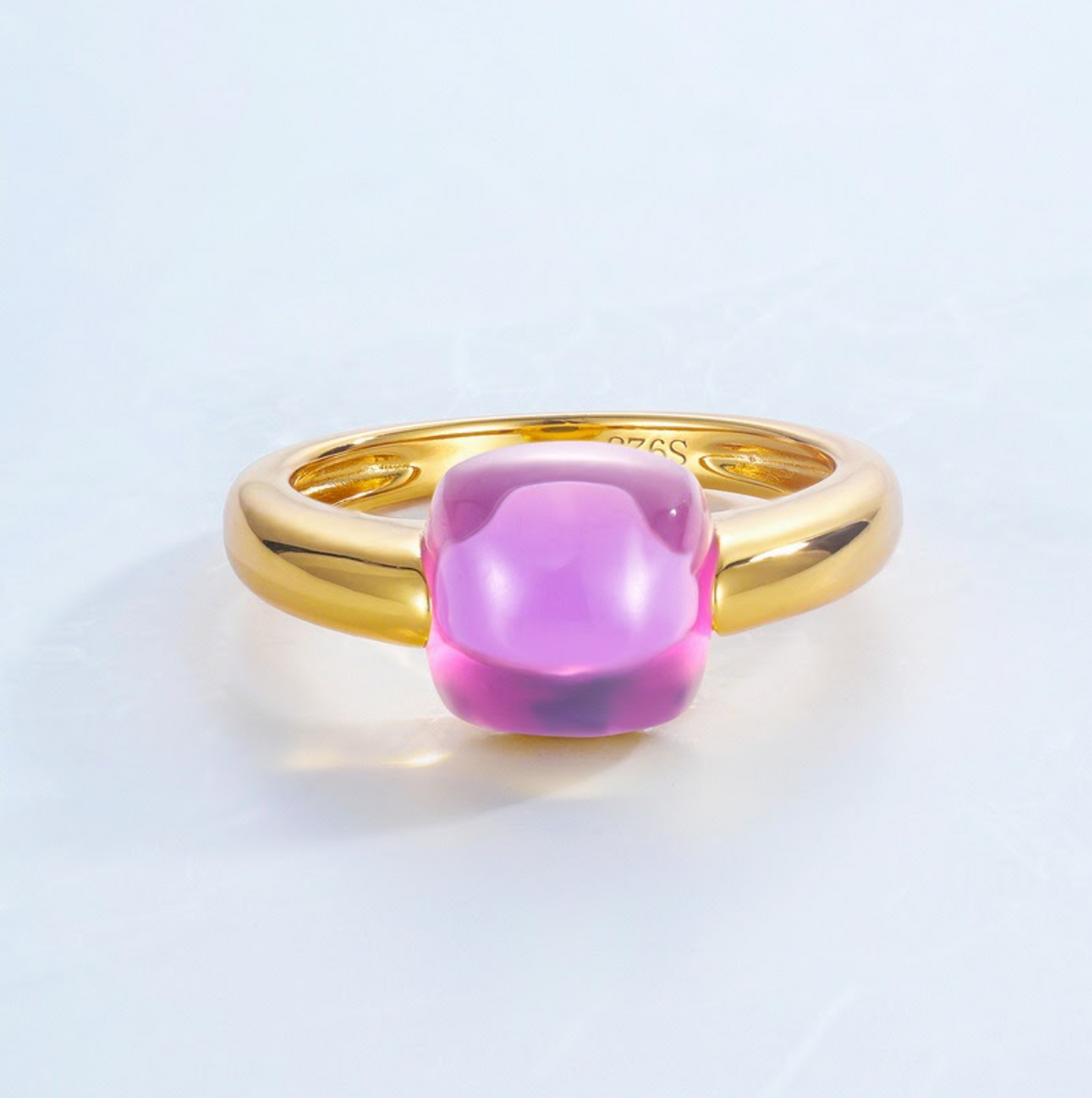 Gold ring with a pink gemstone on a light gray background  - Ali & Eve Jewels