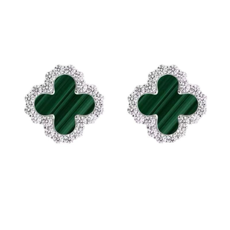 Pair of green clover-shaped earrings with diamond-like accents on a white background - Ali & Eve Jewels