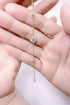 Delicate gold necklace with a small diamond pendant held between fingers  - Ali & Eve Jewels