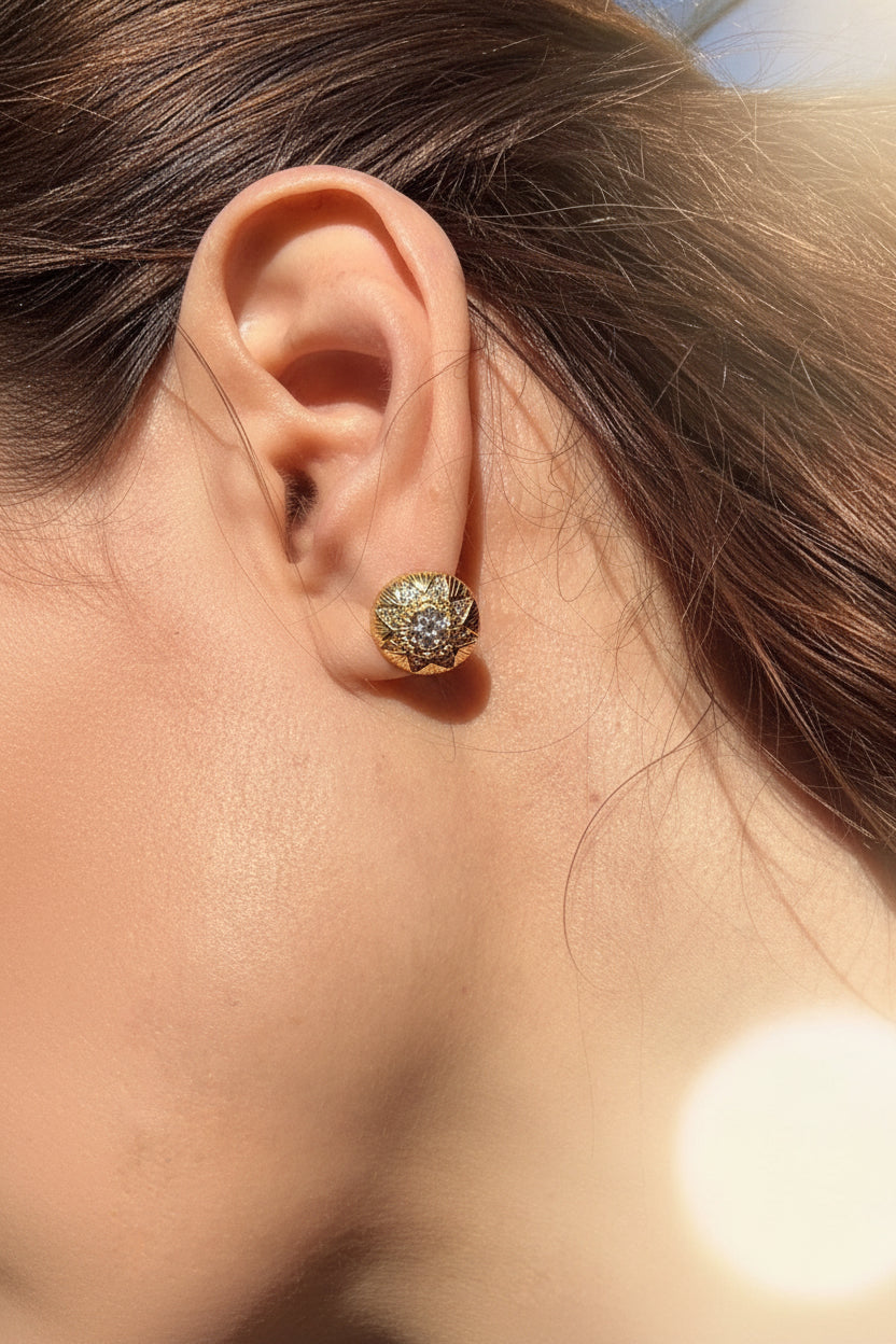 Gold earring worn by a person - Ali & Eve Jewels