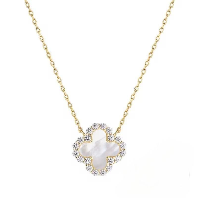 18k yellow gold necklace by Van Cleef & Arpels featuring an iconic Vintage Alhambra clover pendant centered on a white background with an iridescent mother-of-pearl inlay and a shimmering border of pavé-set diamonds